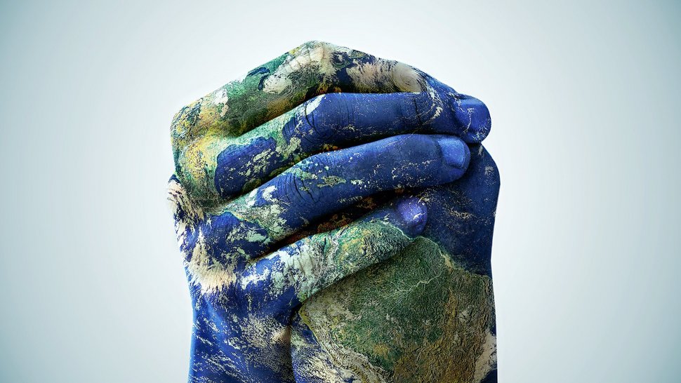 Two hands are clasped and intertwined. They are painted with a motif of the earth seen from above. Blue sea and continents are visible.